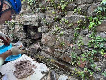 Lime mortar wall repairs.