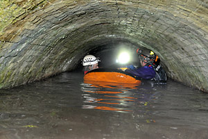 Evan (left) and Tony (right) clinging onto the dingy, with Stuart’s light receding into the distance.